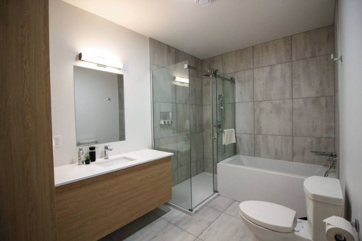 Salle de bain spacieuse et lumineuse du Condo 304 au 800 St-Jovite, avec douche vitrée et baignoire séparée à Mont-Tremblant.